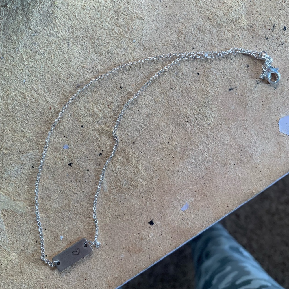 Silver bar with a heart necklace for $5 never worn.